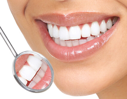 dental mirror next to woman's smiling mouth, bright white straight teeth, cosmetic dentistry Baytown, TX dentist