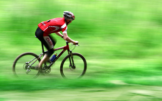 man riding bicycle fast, Athletic Mouthguards San Diego, CA dentist
